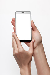 Female hands holding smartphone with blank screen. Touchscreen isolated with clipping paths