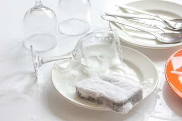 concept of woman washing dishes on white background