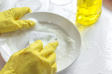 concept of woman washing dishes on white background