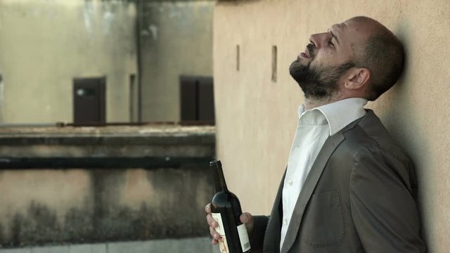 drunk businessman drinking wine  goes crazy