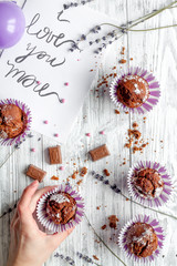 concept of Valentine's Day cupcakes wooden background top view