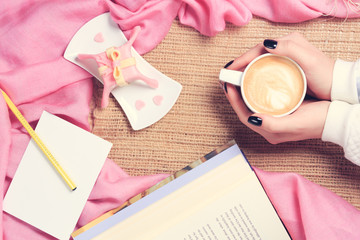 Girl holding cup of coffee with latte art. Valentines day and le
