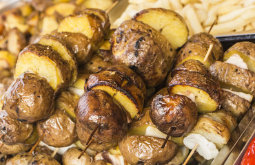 Roasted potato in bowl on wooden table