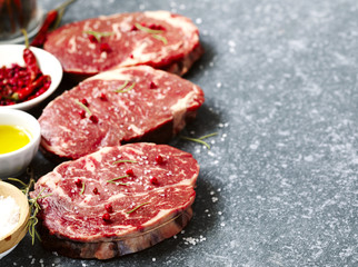 Raw fresh meat Ribeye Steak with rosemary, pepper and sea salt o