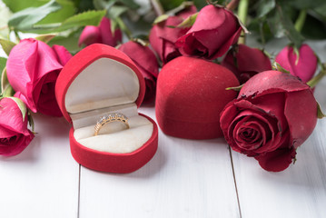 Diamond wedding ring in box gift on wood