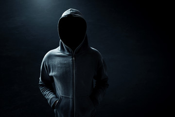 Hacker standing alone in dark room - obrazy, fototapety, plakaty