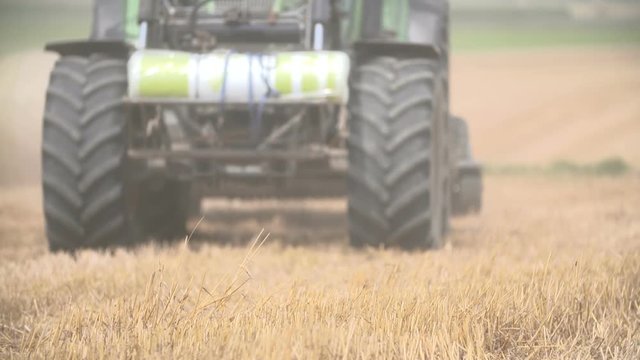 bales of hay, tractor working in field