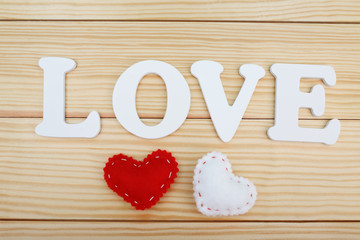 White LOVE text on wooden background