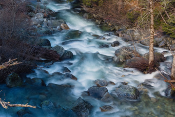 Long exposure of a creek full of spring snowmelt in a granite canyon in the Trinity Alps