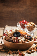 Healthy food: nuts and dried fruit, vintage wooden background, s