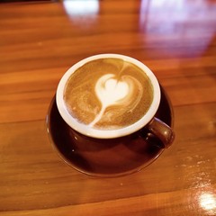 hot cappuccino on wooden table