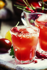Tomato cocktail with pepper vodka, orange juice and ice, wooden
