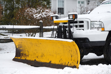 truck with snowplow installed in the residential street