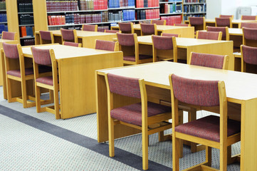 interior view of library with tables and chairs in university
