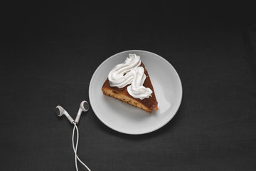 Cupcake with headphones on a black background