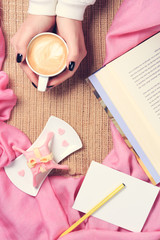 Girl holding cup of coffee with latte art. Valentines day and le