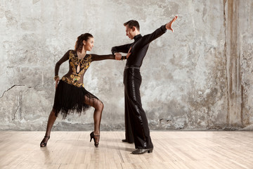 Beautiful couple in the active ballroom dance on wall - obrazy, fototapety, plakaty