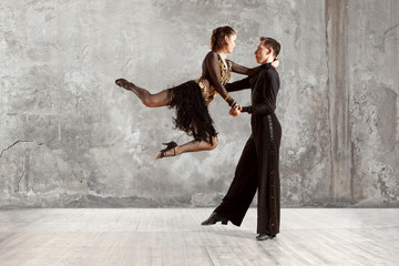 Beautiful couple in the active ballroom dance on wall
