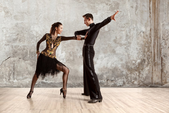 Beautiful couple in the active ballroom dance on wall