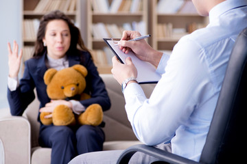 Woman with bear toy during psychologist visit