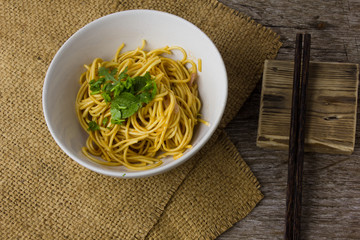 The spaghetti in a white plate on the table