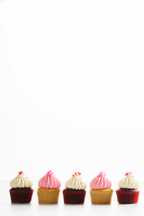 colorful cupcakes on white wooden background