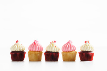 colorful cupcakes on white wooden background