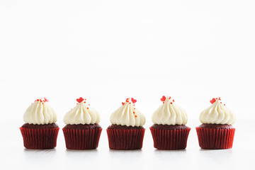 colorful cupcakes on white wooden background