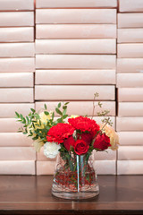 beautiful red roses on wooden table