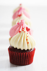 colorful cupcakes on white wooden background