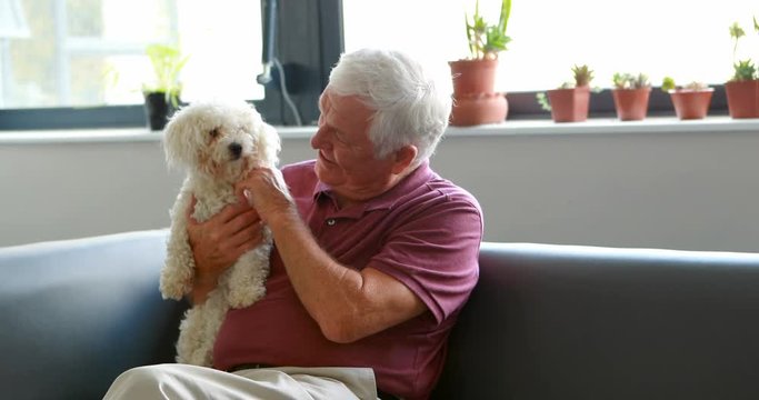 Senior man pampering dog