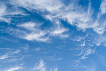 White clouds of unusual shape on a blue sky in winter