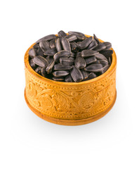 sunflower seeds spill out of wooden barrels on white