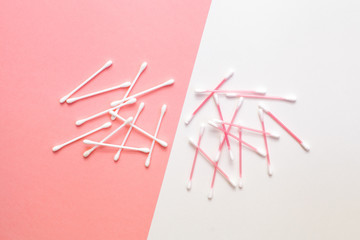 Creative and minimalistic flat lay of cotton pads on a pink and white background