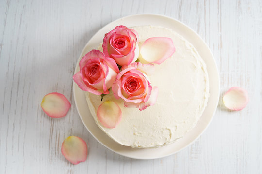 Sweet White Buttercream Cake With Pink Rose Flowers On Top