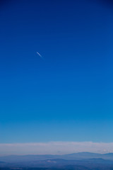 Mountains, sky and a plane
