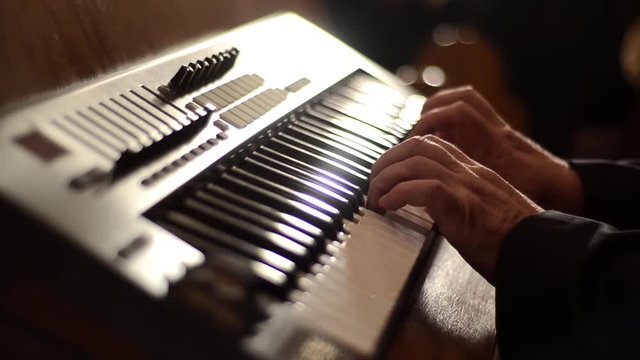 Man playing a church organ on Christmas Midnight Eve