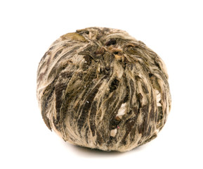Single ball of aromatic flower green chinese tea isolated on white background