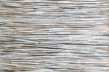 The textured natural background from a wooden of dry twigs wattle fence