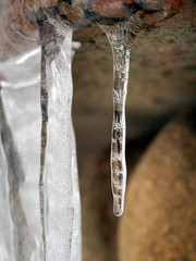 Naklejka na ściany i meble Beautiful icicle with ice patterns on the inside