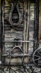 old wooden parts of wagon hanging on a wooden wall on the farm