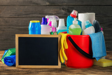 Variety cleaning product with empty chalkboard on wooden table