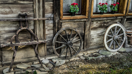 Fototapeta premium old wooden parts of wagon standing near the house