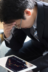 Stressed out businessman sitting at bedroom