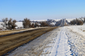 Obraz premium Broken cracked asphalt road on winter