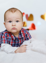 Beautiful baby is smiling. background as a heart.