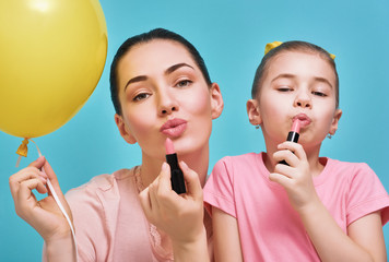 Mother and daughter are doing makeup