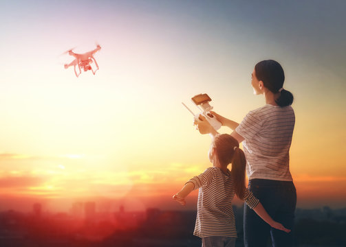 Kid and mom playing with drone
