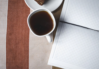 Сoffee mug, cake, notebook