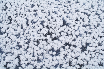 white snowflakes on blue ice